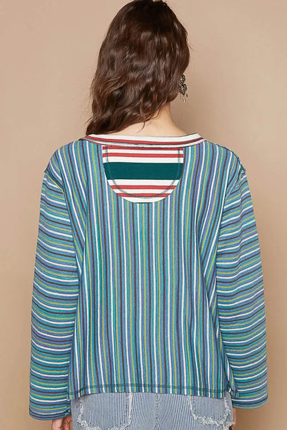 Woman wearing a multicolored vertical striped long sleeve top, shown from the back