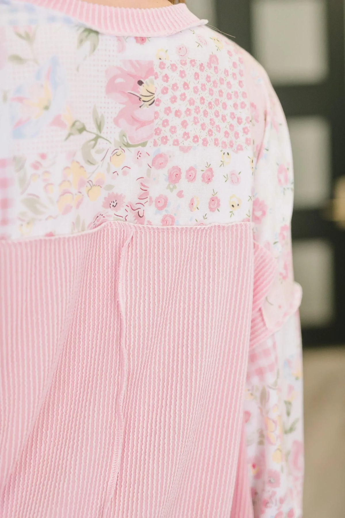 Back view of a women’s top with pink striped and floral patchwork fabric details