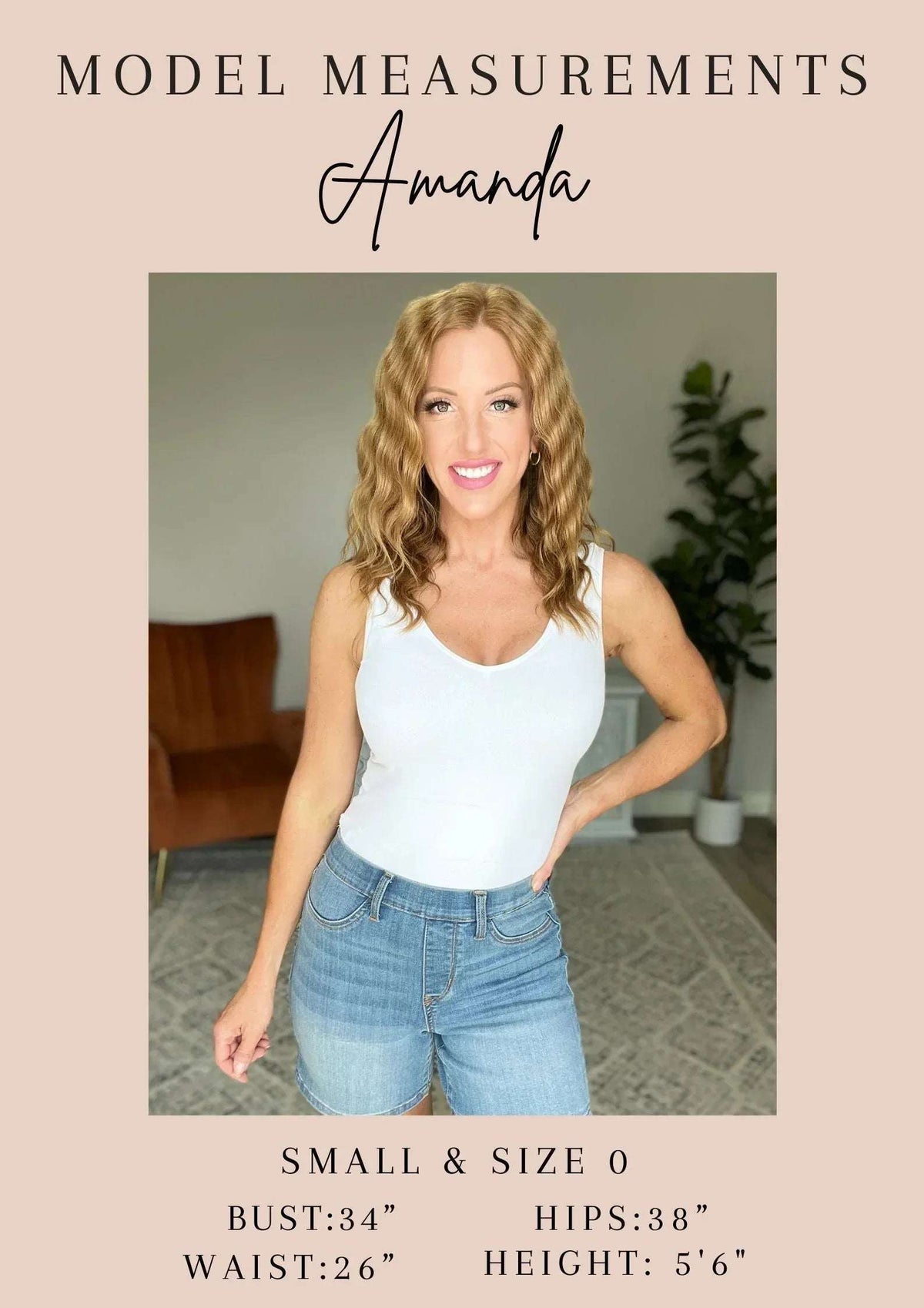 Woman modeling casual summer outfit with white tank top and high-waisted denim shorts indoors