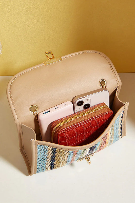 Open beige crossbody bag with woven front, holding a phone, wallet, and cardholder