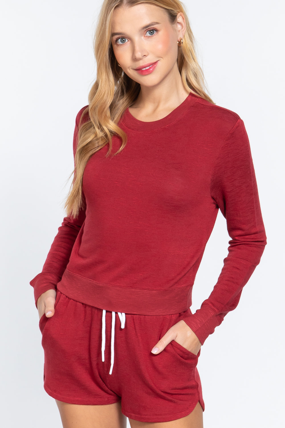 Woman wearing a red Long Sleeve Crew Neck Slub Terry Top with matching shorts on a white background