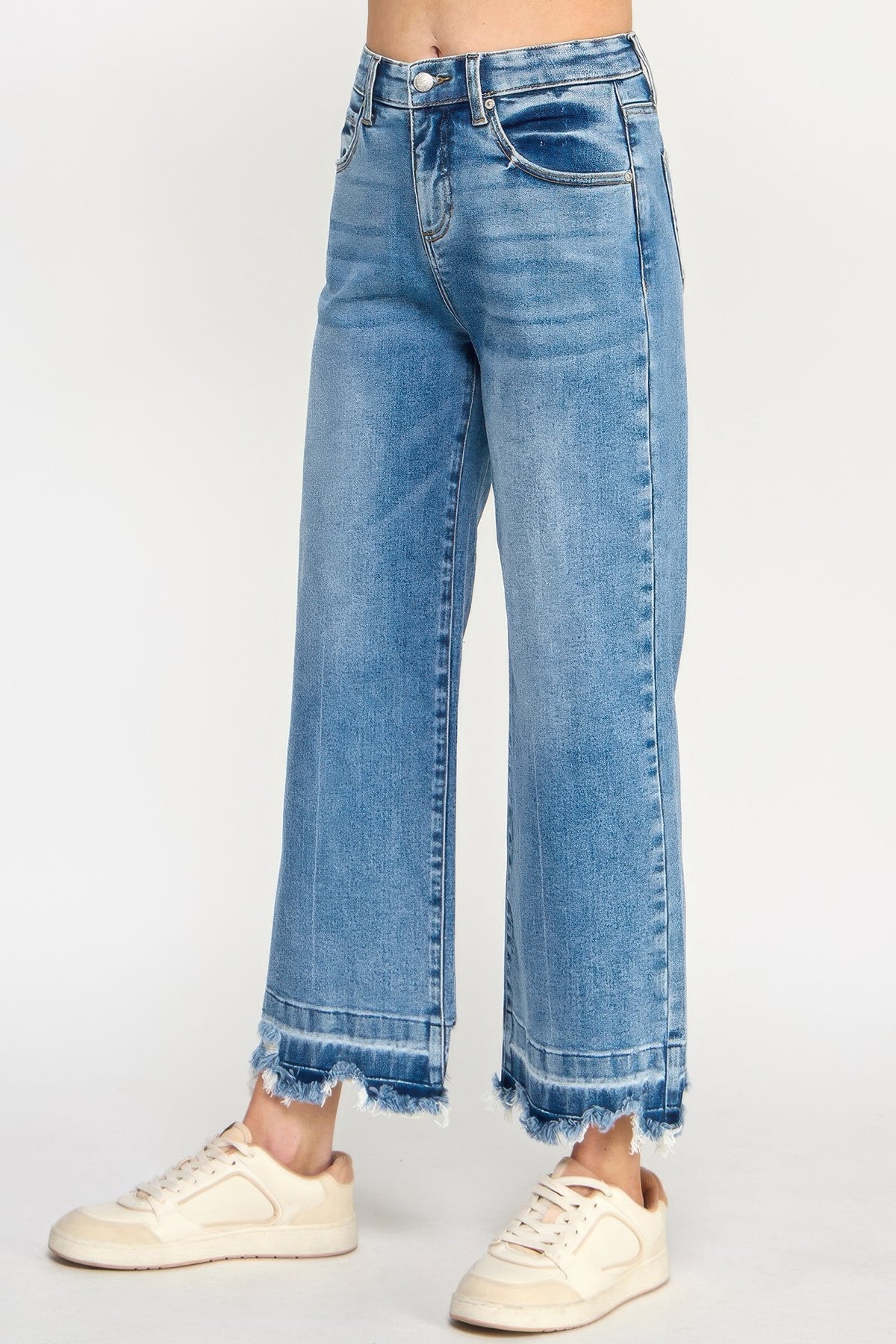 Tummy Control Cropped Wide Leg Jeans with a frayed hem worn by a woman on a white background