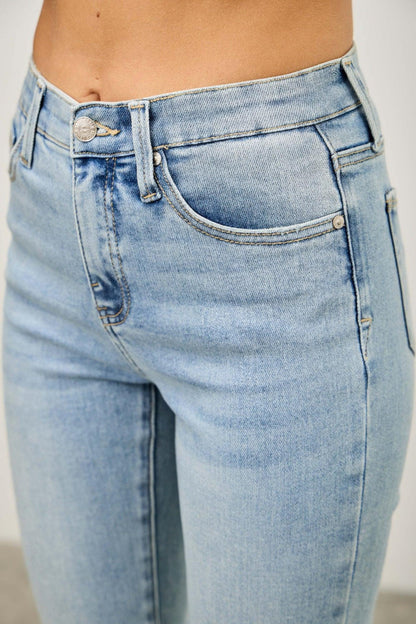 Close up of light wash high-rise women's jeans with classic five-pocket design