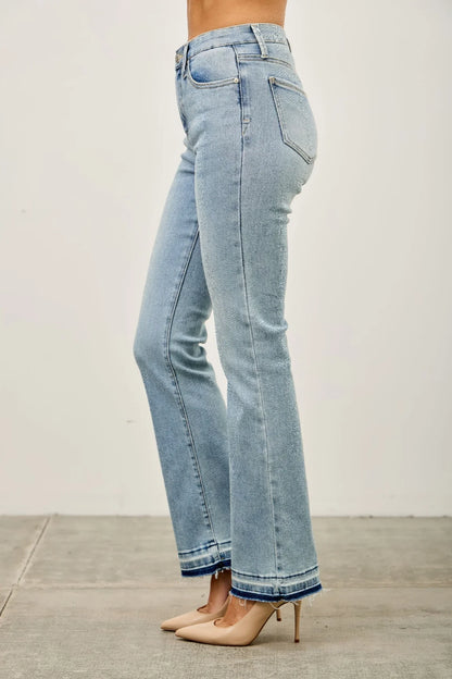 Light wash high-rise straight leg jeans with raw hem, styled with nude heels