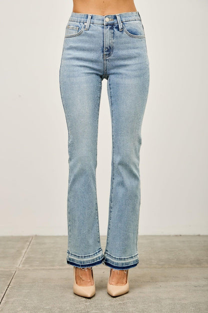 Light wash high-waisted straight leg jeans with raw hem, shown on model, studio background