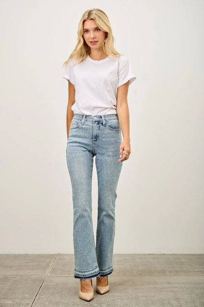 Woman wearing high-waisted straight-leg light wash jeans, white t-shirt and nude heels
