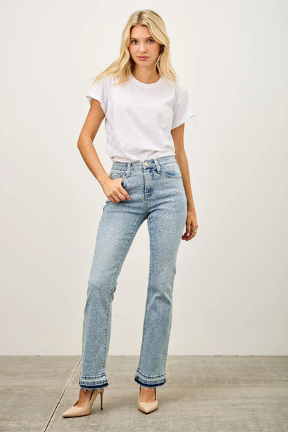 Woman in light wash high-rise straight jeans, white t-shirt, and nude heels
