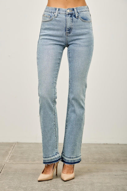 High-rise straight leg light wash jeans with raw hem, styled with nude heels