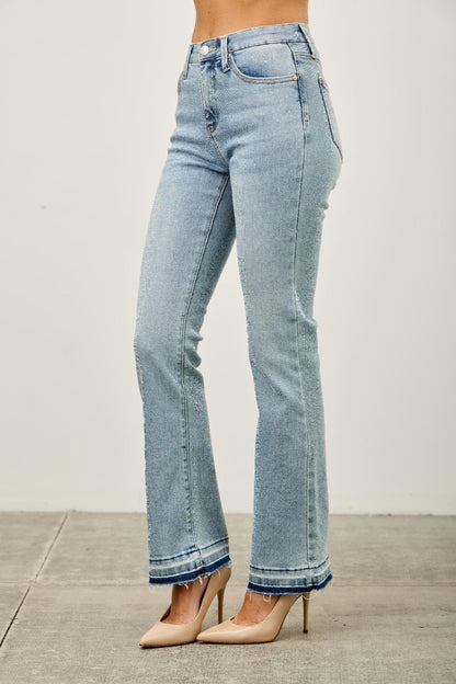 Light wash high-waisted flared jeans with frayed hems, styled with nude heels