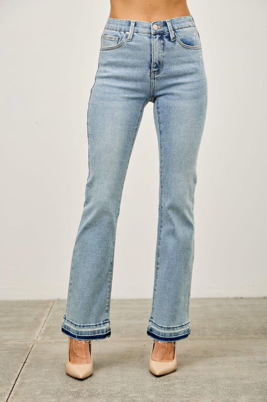 Light wash high-rise straight leg jeans with raw hem, paired with nude heels