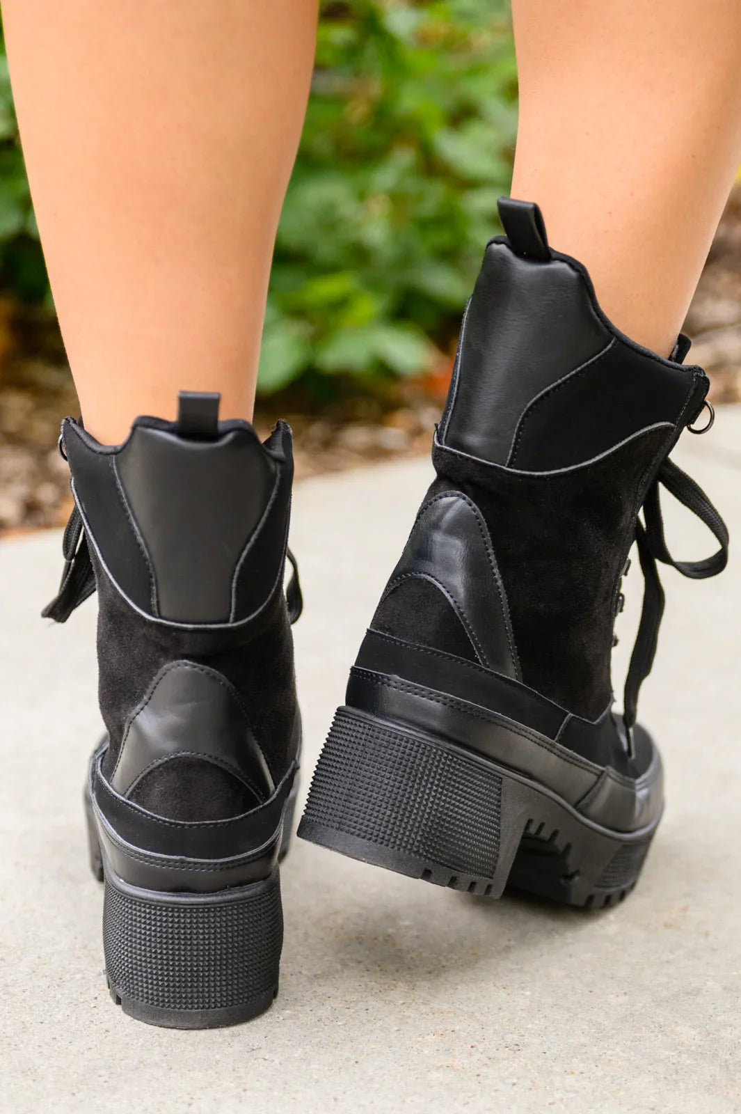 Black lace-up combat boots with chunky heels and mixed leather and suede texture