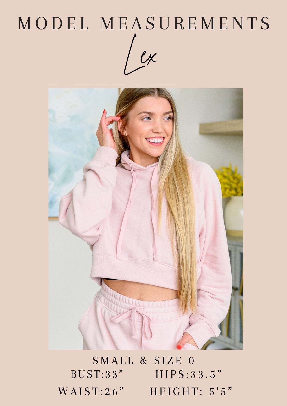 Woman wearing a pink hoodie and pants with model measurements displayed.