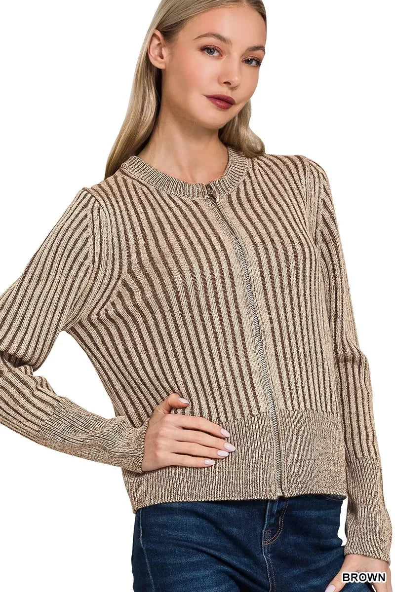 Woman wearing a brown striped knit sweater with round neck and front zipper, paired with jeans.