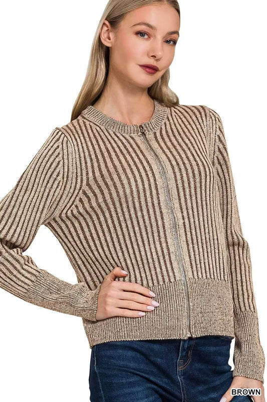 Woman wearing a brown striped knit sweater with round neck and front zipper, paired with jeans.