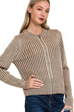 Woman wearing a brown striped knit sweater with round neck and front zipper, paired with jeans.