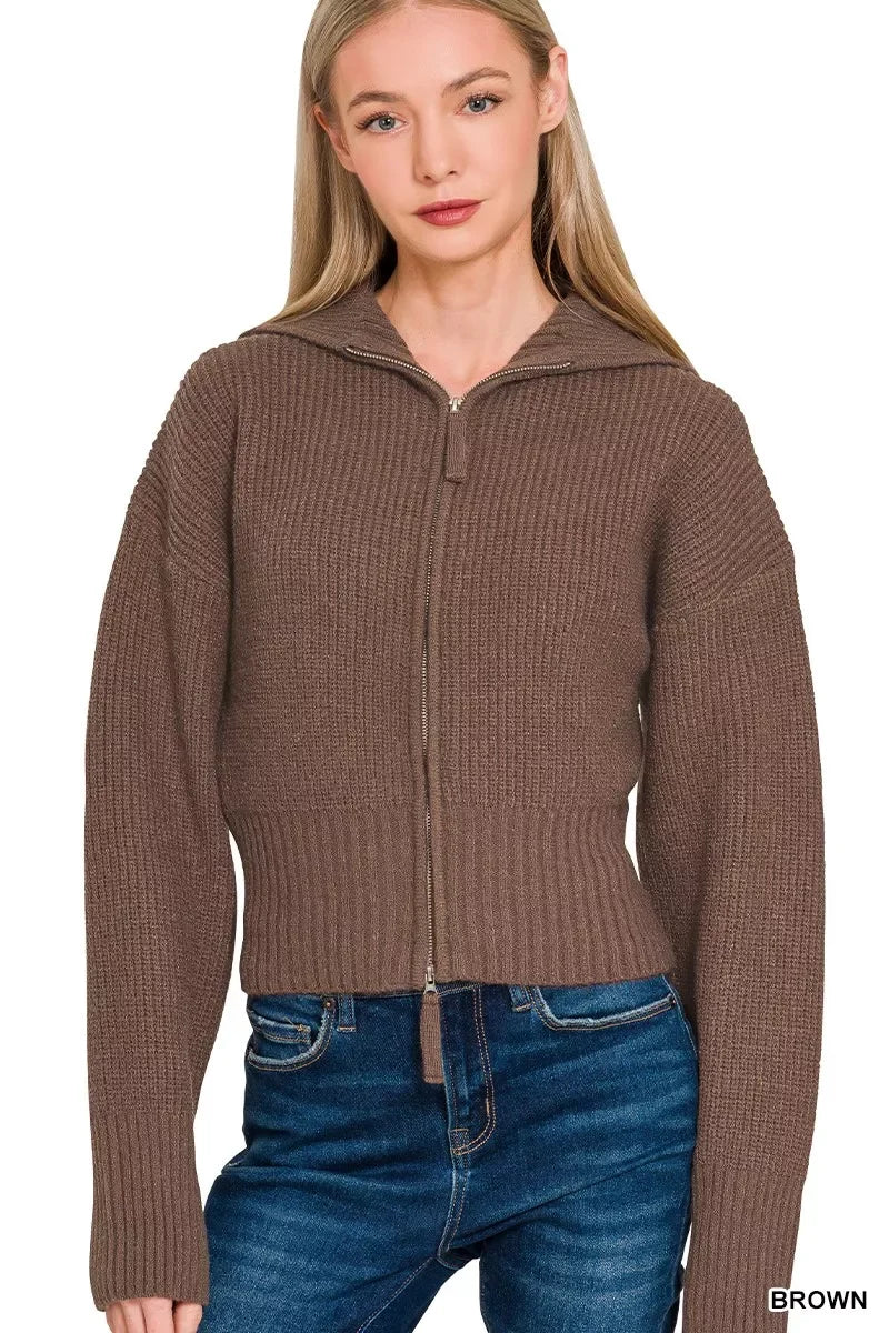 Woman wearing brown knit zip-up hoodie with ribbed texture and blue jeans