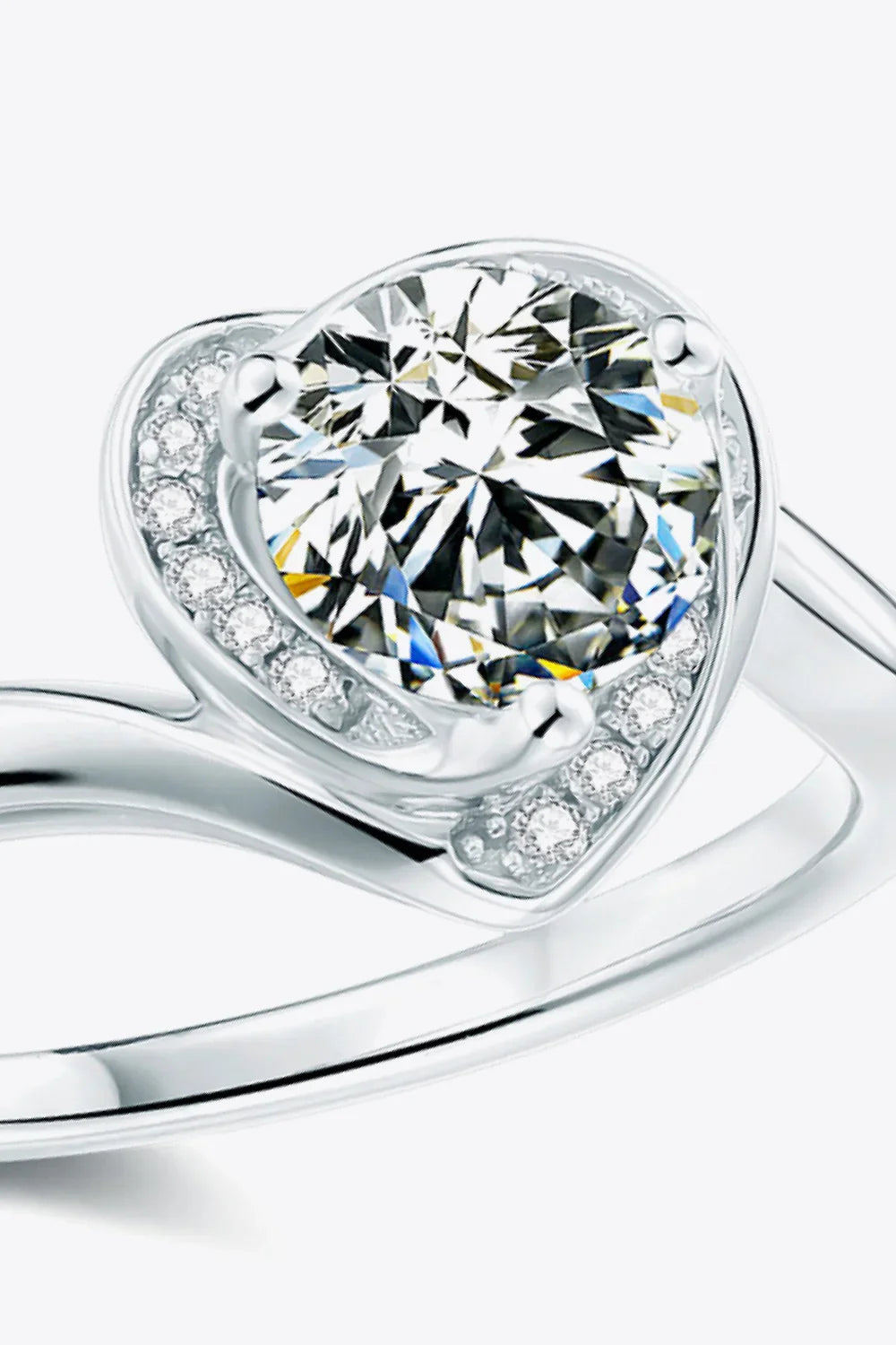 Close-up of a silver ring with a large round center stone and smaller accent diamonds