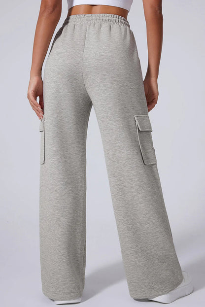 Back view of woman wearing light grey wide-leg cargo sweatpants with side pockets