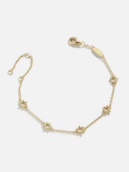 Gold chain bracelet with star charms on white background