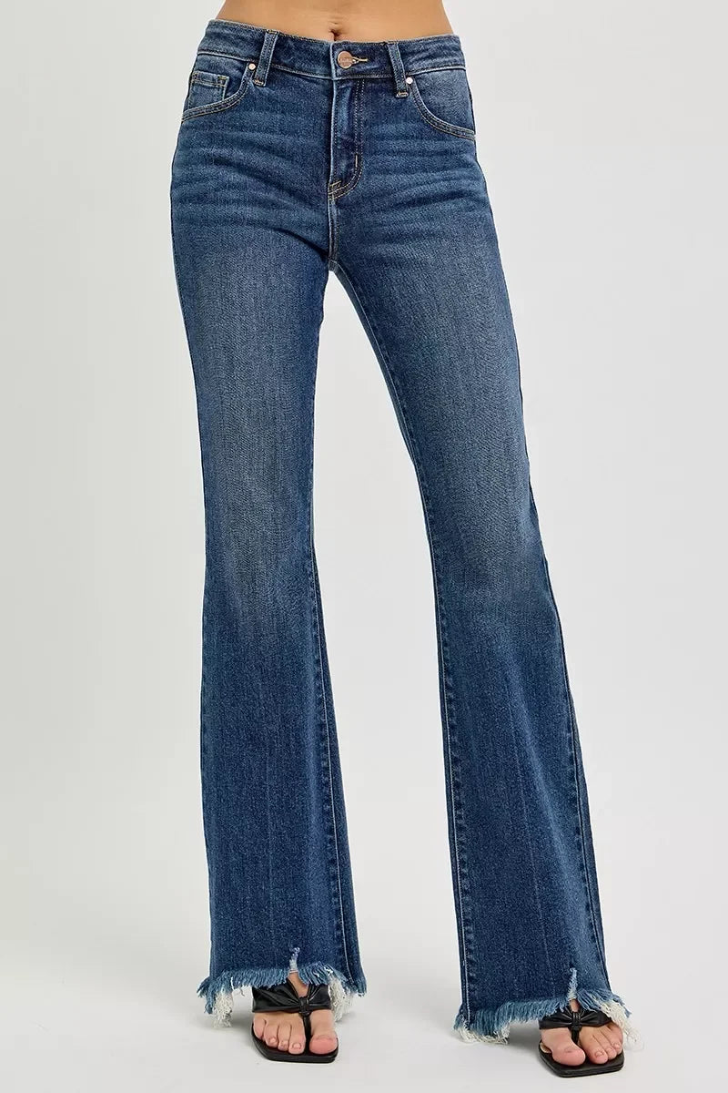 Women's high-waisted flared jeans with raw frayed hems in medium blue denim