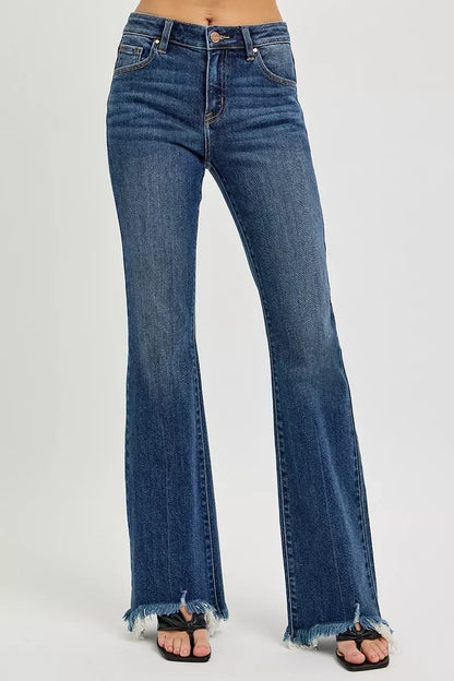 Women's high-waisted flared jeans with raw frayed hems in medium blue denim