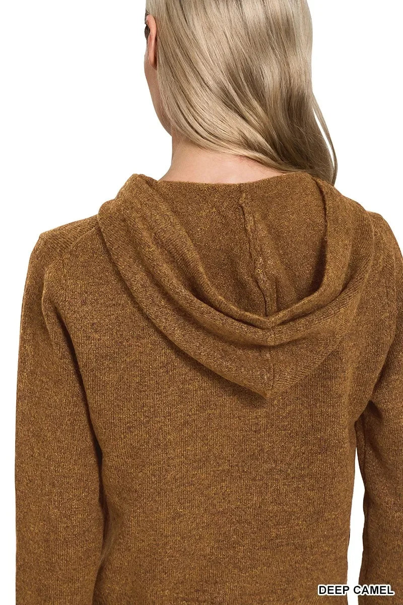 Back view of a woman wearing a deep camel brown knit hooded sweater.