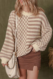 Woman in beige striped and checkered knit sweater, brown mini skirt, and cream shoulder bag