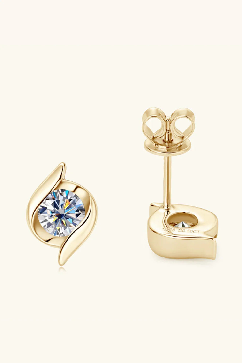 Gold stud earrings with round clear stones and leaf-inspired design on a neutral background