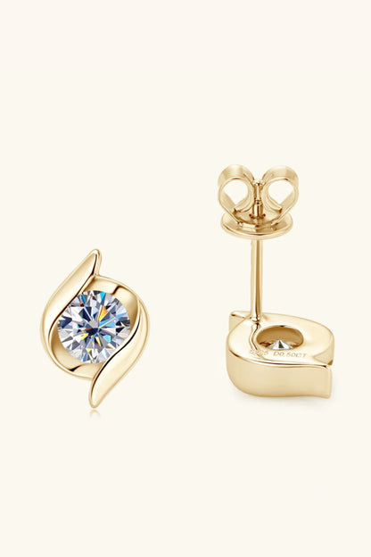 Gold stud earrings with round clear stones and leaf-inspired design on a neutral background