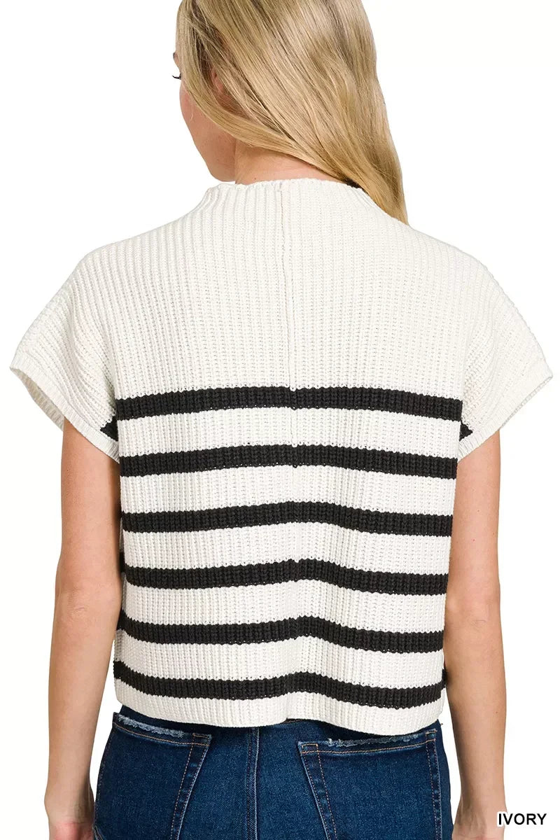 Back view of a woman wearing an ivory knit short-sleeve top with black horizontal stripes.