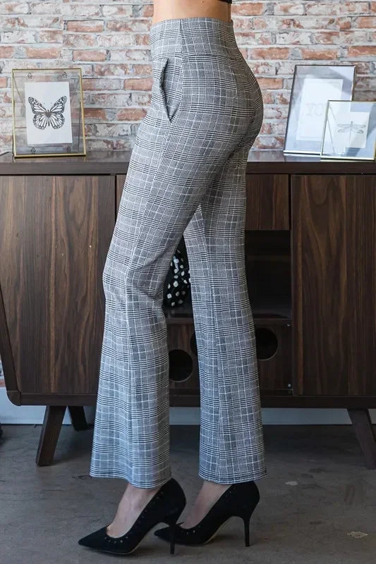 High-waisted gray plaid trousers with a relaxed fit, styled with black heels indoors.