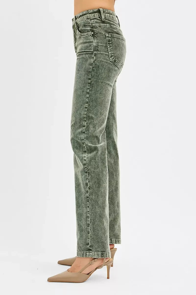 High-waisted green washed straight leg jeans styled with nude heels on model