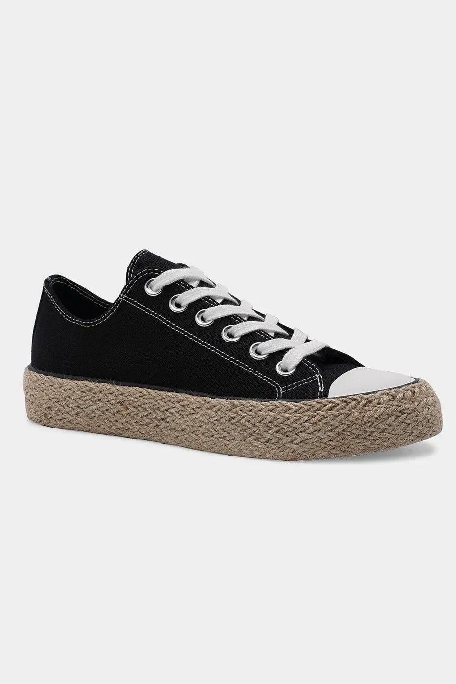Black canvas low-top sneaker with white laces and woven jute platform sole on white background