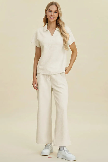 Woman wearing a cream textured short sleeve top and wide-leg pants set, casual style