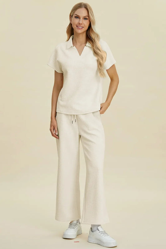 Woman wearing a cream textured short sleeve top and wide-leg pants set, casual style