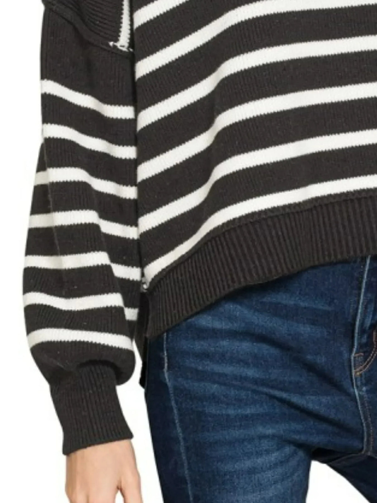 Black and white striped knit sweater with balloon sleeves, paired with dark blue jeans.