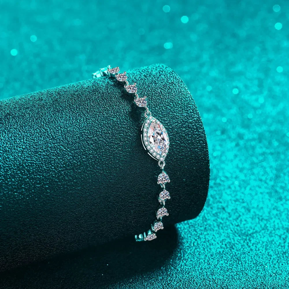 Silver bracelet with marquise and round clear crystals on teal textured background