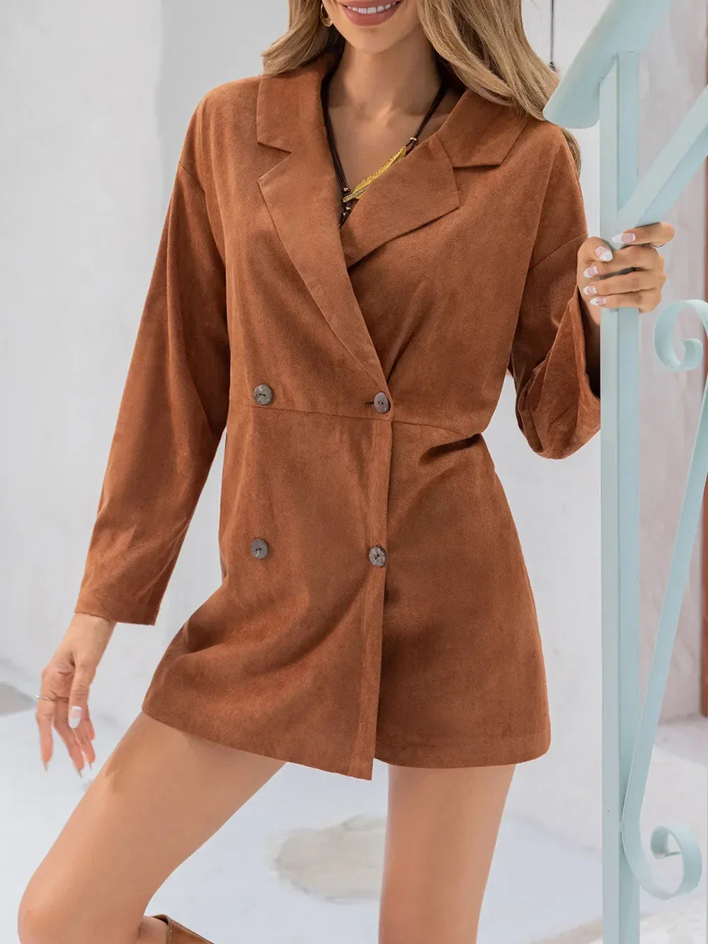 Woman wearing a brown long sleeve blazer dress with double-breasted buttons