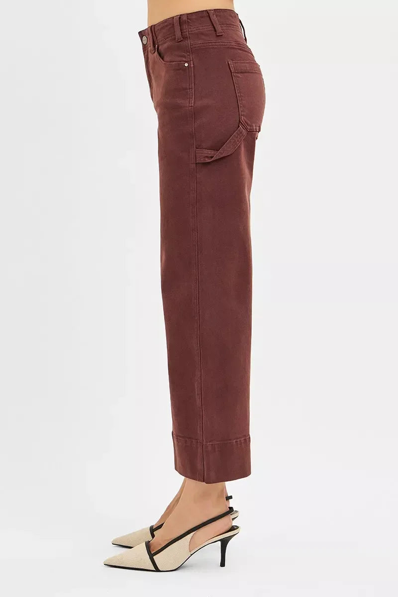 Side view of woman wearing high-waisted, brown cropped pants and beige heels