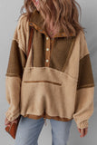 Woman wearing a colorblock sherpa fleece pullover with snap buttons and light wash jeans