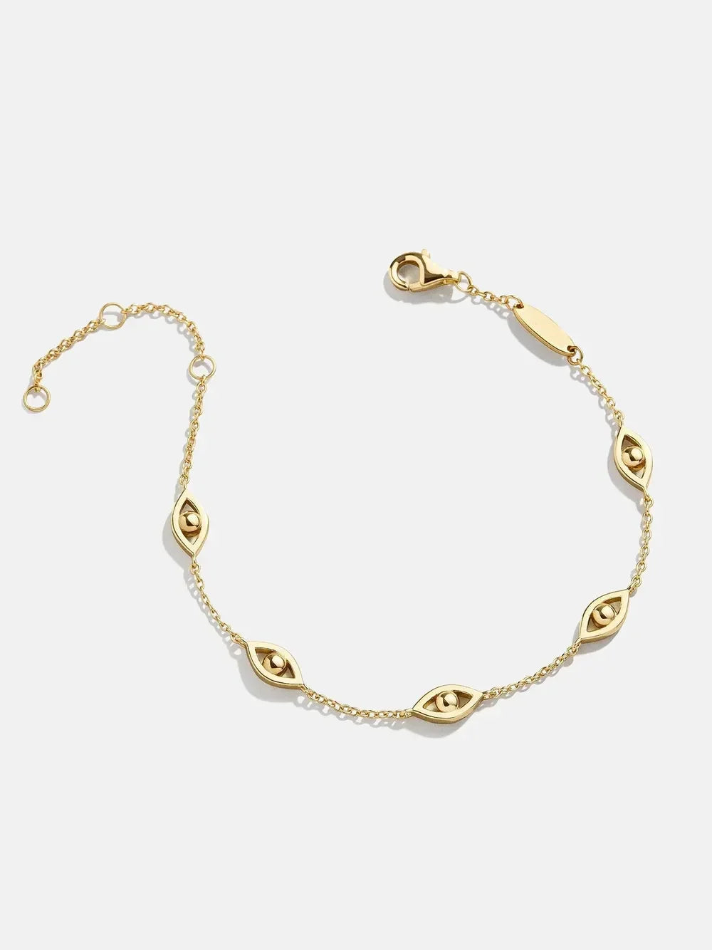 Delicate gold chain bracelet with marquise-shaped eye charm accents on a white background