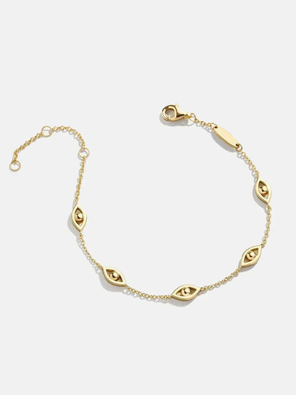 Delicate gold chain bracelet with marquise-shaped eye charm accents on a white background