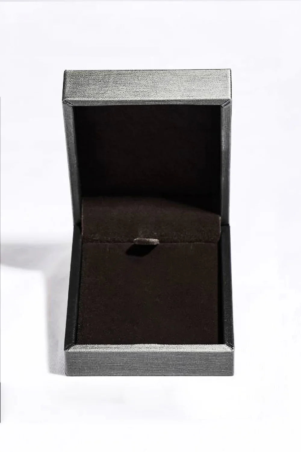 Open black velvet jewelry box on white background, empty and ready for a necklace or ring