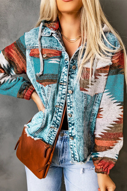 Woman wearing an Aztec print denim jacket with blue jeans and a brown crossbody bag.
