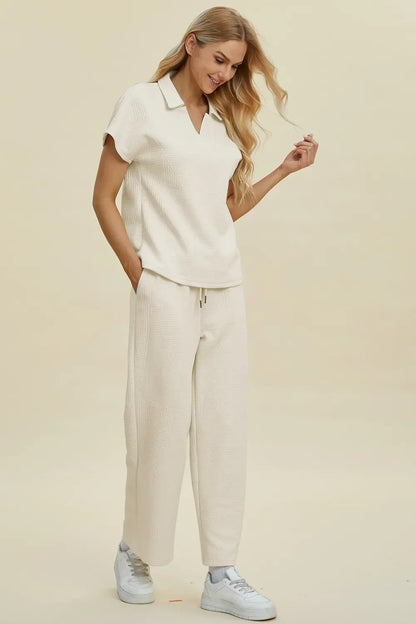Woman wearing cream textured knit short-sleeve top and wide-leg pants set