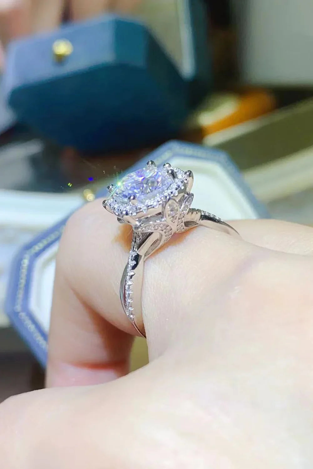 Close-up of an elegant silver engagement ring with a large round gemstone and intricate detailing