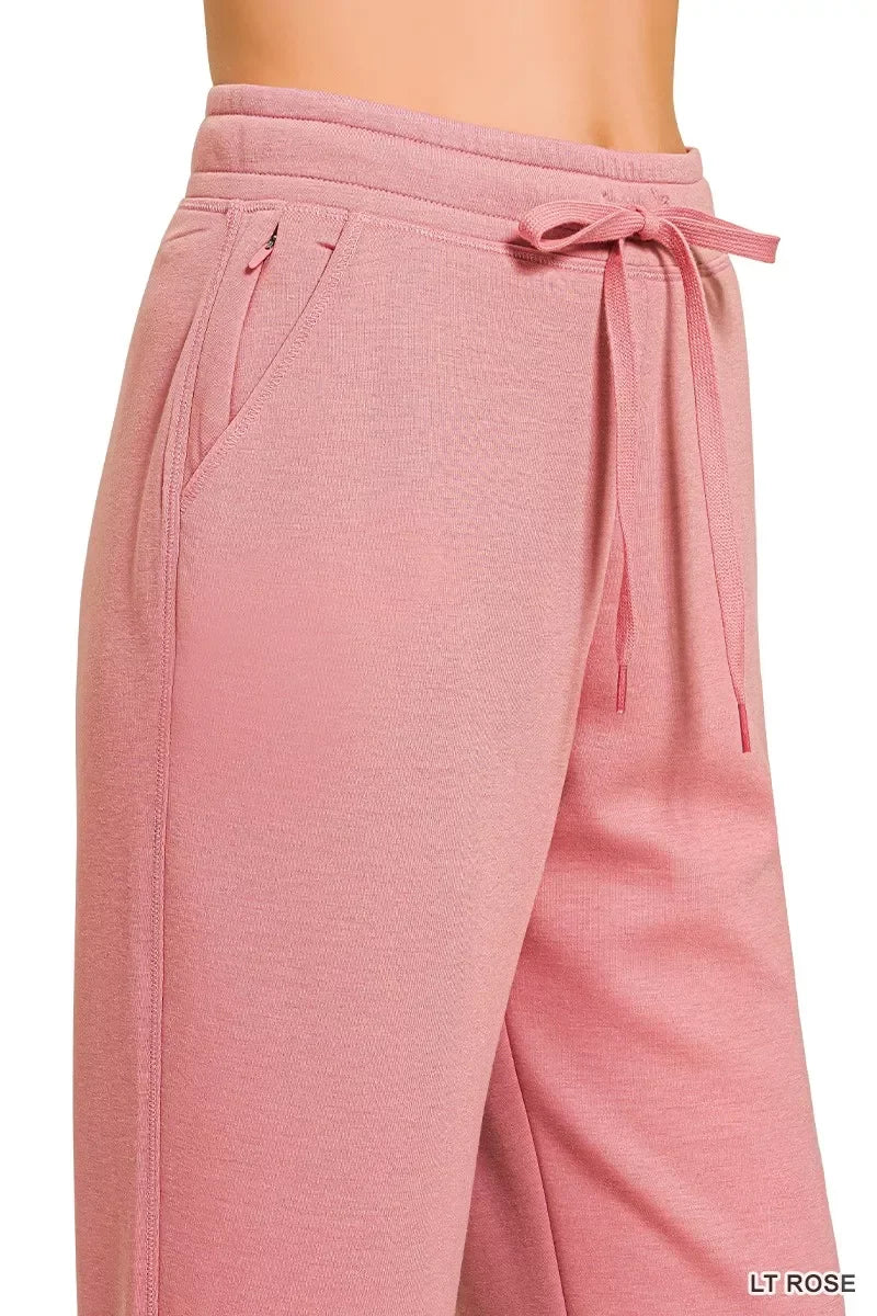 Close-up of light rose pink women's lounge pants with drawstring waist and side pocket