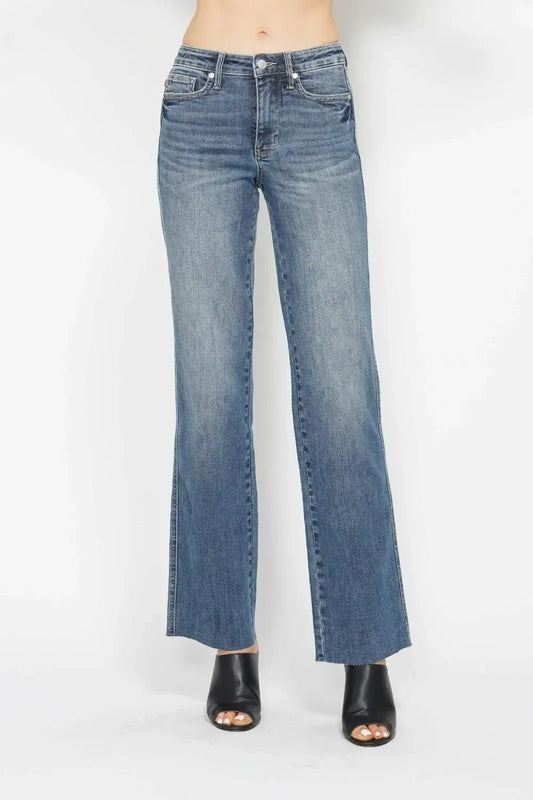 Wide-leg blue denim jeans with faded wash, styled with black open-toe heeled sandals.