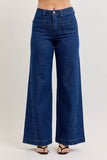 High-waisted wide-leg dark denim jeans with front patch pockets, modeled on a white background.