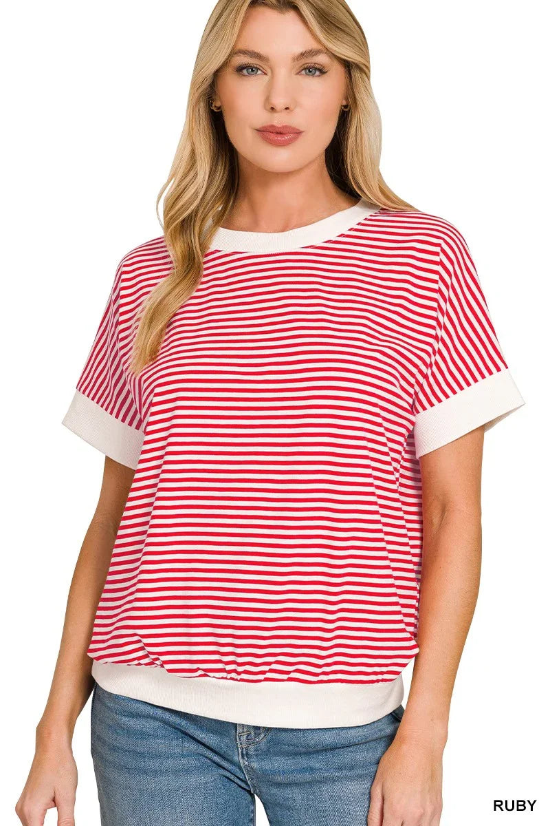 Woman wearing a red and white striped short sleeve top with relaxed fit and white trim.